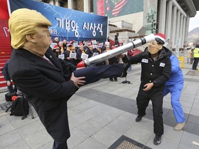 A protester, left, wearing a mask of U.S. President Donald Trump kicks his fellow protester wearing a mask of North Korean leader Kim Jong Un during a rally to denounce policies of South Korean President Moon Jae-in on North Korea in Seoul, South Korea, Tuesday, Dec. 18, 2018. Kim's return visit to Seoul appears unlikely to take place this month, a senior South Korean official said last week.