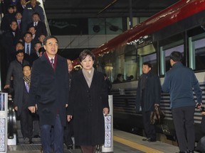 South Korean Unification Minister Cho Myoung-gyon, bottom left, and officials arrive to board a train to leave for the North Korea at the Seoul Railway Station in Seoul, South Korea, Wednesday, Dec. 26, 2018. South Korean officials have traveled to North Korea by train to attend a groundbreaking ceremony for an aspirational project to modernize North Korean railways and roads and connect them with the South.