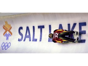 FILE - In this Feb. 9, 2002, file photo, Georg Hackl, of Germany, speeds past an Olympic logo during a practice run for the men's singles luge at the 2002 Salt Lake City Winter Olympics in Park City, Utah. Salt Lake City got the green light to bid for an upcoming Winter Olympics most likely for 2030 in an attempt to bring the Games back to the city that hosted in 2002 and provided the backdrop for the U.S. winter team's ascendance into an international powerhouse.