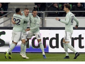 Bayern's Joshua Kimmich, 2nd left, celebrates after scoring the opening goal during the German Bundesliga soccer match between Hannover 96 and FC Bayern Munich in Hannover, Germany, Saturday, Dec. 15, 2018.