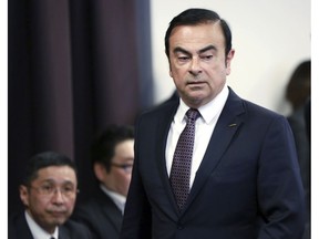 FILE - In this May 12, 2016, file photo, then Nissan Motor Co. President and CEO Carlos Ghosn arrives for a joint press conference with Mitsubishi Motors Corp. in Yokohama, near Tokyo.  At left is Nissan Chief Executive Hiroto Saikawa. Nissan's board is meeting to pick a chairman to replace Carlos Ghosn, arrested last month on charges of violating financial regulations. The Dec. 17, 2018, meeting comes amid an unfolding scandal that threatens the Japanese automaker's two-decade alliance with Renault SA of France and its global brand, as well as highlighting shoddy governance.