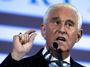 FILE - In this Dec. 6, 2018, file photo, Roger Stone speaks at the American Priority Conference in Washington Thursday, Dec. 6, 2018.  Former Trump campaign adviser Stone has settled a $100 million lawsuit accusing him of publishing lies on the far-right InfoWars website. The Wall Street Journal reports exiled Chinese businessman Guo Wengui sued Stone in March, saying Stone accused him of being a "turncoat criminal" who violated U.S. election law. Stone now says his conduct was "irresponsible."