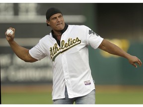 FILE - In this Sept. 3, 2016, file photo, former Oakland Athletics player Jose Canseco throws out the ceremonial first pitch prior to a baseball game against the Boston Red Sox in Oakland, Calif. Canseco, a former major league slugger, has made his pitch for a big job at the White House, tweeting Wednesday, Dec. 12, 2018, to U.S. President Donald Trump: "u need a bash brother for Chief if (sic) Staff."