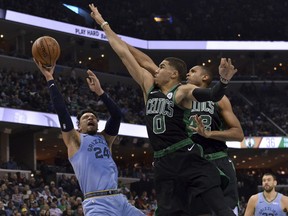 Memphis Grizzlies guard Dillon Brooks (24) shoots against Boston Celtics forward Jayson Tatum (0) and center Al Horford (42) during the first half of an NBA basketball game Saturday, Dec. 29, 2018, in Memphis, Tenn.