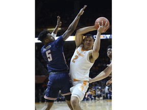 Tennessee forward Grant Williams (2) tries to pass around Samford guard DeAndre Thomas (5) during the first half of an NCAA college basketball game, Wednesday, Dec. 19, 2018 in Knoxville, Tenn.
