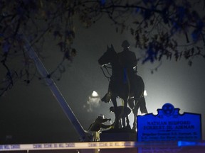 FILE - In this Dec. 20, 2017, file photo, workers remove the Nathan Bedford Forrest statue from Health Sciences Park in Memphis, Tenn. Descendants of Nathan Bedford Forrest are claiming that the graves of the Confederate general and his wife were desecrated when a statue of him was removed from the Tennessee park last year. Forrest's great-great-grandsons filed a lawsuit in a Memphis court Monday seeking damages and possession of the statue after it was taken down in December 2017.