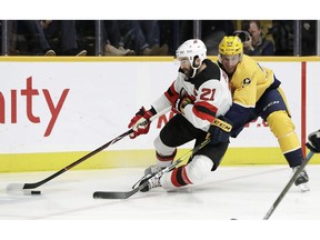 New Jersey Devils right wing Kyle Palmieri (21) is defended by Nashville Predators' Roman Josi (59), of Switzerland, in the first period of an NHL hockey game Saturday, Dec. 15, 2018, in Nashville, Tenn.