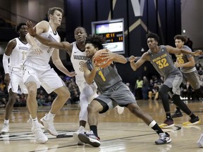 Arizona State guard Remy Martin (1) drives against Vanderbilt guard Maxwell Evans (3) in the first half of an NCAA college basketball game Monday, Dec. 17, 2018, in Nashville, Tenn.