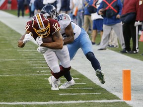 Washington Redskins wide receiver Michael Floyd (17) scores a touchdown on a 7-yard reception as he is defended by Tennessee Titans cornerback Adoree' Jackson (25) in the first half of an NFL football game Saturday, Dec. 22, 2018, in Nashville, Tenn.