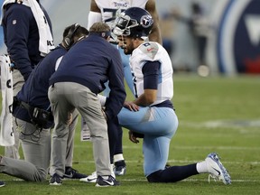Tennessee Titans quarterback Marcus Mariota is attended to after being injured in the first half of an NFL football game against the Washington Redskins Saturday, Dec. 22, 2018, in Nashville, Tenn.