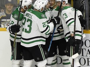 Dallas Stars center Tyler Pitlick (18) celebrates with teammates after scoring a goal against the Nashville Predators during the first period of an NHL hockey game Thursday, Dec. 27, 2018, in Nashville, Tenn.