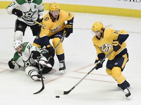 Nashville Predators center Calle Jarnkrok (19), of Sweden, gets control of the puck after stealing it away from Dallas Stars center Tyler Seguin (91) during the first period of an NHL hockey game Thursday, Dec. 27, 2018, in Nashville, Tenn.