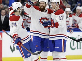 Montreal Canadiens defenseman Jordie Benn (8) celebrates his goal against the Tampa Bay Lightning with center Phillip Danault (24) and defenseman Brett Kulak (17) during the first period of an NHL hockey game Saturday, Dec. 29, 2018, in Tampa, Fla.