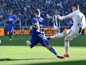 Juventus Cristiano Ronaldo, right, scores his side's opening goal during the Italian Serie A soccer match between Juventus and Sampdoria at Allianz stadium in Turin, Italy,  Dec. 29, 2018.
