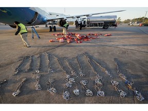 In this Nov. 16, 2018, photo, personal belongings of immigrants who entered the United States illegally are loaded onto a plane for a deportation flight to El Salvador by U.S. Immigration and Customs Enforcement in Houston. An obscure division of U.S. Immigration and Customs Enforcement operates hundreds of flights each year to remove immigrants.