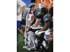 Philadelphia Eagles quarterback Carson Wentz (11) sits on the bench during the first half of an NFL football game against the Dallas Cowboys, in Arlington, Texas, Sunday, Dec. 9, 2018.