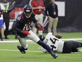 Houston Texans wide receiver DeAndre Hopkins (10) runs past Jacksonville Jaguars middle linebacker Myles Jack (44) after making a catch during the first half of an NFL football game, Sunday, Dec. 30, 2018, in Houston.