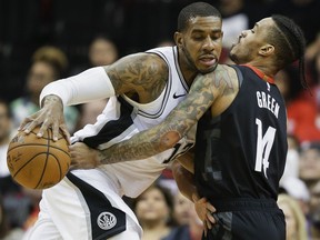 San Antonio Spurs forward LaMarcus Aldridge, left, dribbles as Houston Rockets guard Gerald Green defends during the first half of an NBA basketball game, Saturday, Dec. 22, 2018, in Houston.