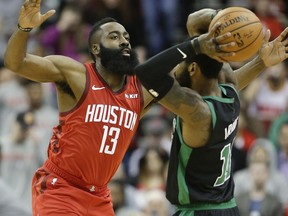 Houston Rockets guard James Harden (13) applies defensive pressure against Boston Celtics guard Kyrie Irving during the first half of an NBA basketball game, Thursday, Dec. 27, 2018, in Houston.