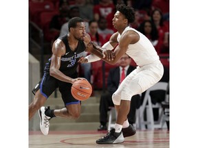 Saint Louis guard Javon Bess (3) fends off Houston guard Nate Hinton, right, as he drives around him during the first half of an NCAA college basketball game Sunday, Dec. 16, 2018, in Houston.