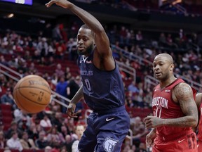 Memphis Grizzlies forward JaMychal Green (0) loses the ball on a drive to the basket in front of Houston Rockets forward PJ Tucker (17) during the first half of an NBA basketball game Monday, Dec. 31, 2018, in Houston.