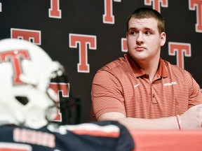 Robert E. Lee offensive lineman Beaux Limmer sits on stage during a national signing day event at Robert E. Lee High School in Tyler, Texas, Wednesday, Dec. 19, 2018. Limmer announced his intentions to attend the University of Arkansas to play college football.