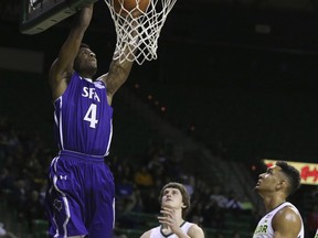 Stephen F. Austin forward Davonte Fitzgerald, left, dunks over Baylor guard Matthew Mayer, and Tristan Clark, right, in the first half of an NCAA college basketball game, Tuesday, Dec. 18, 2018, in Waco, Texas.