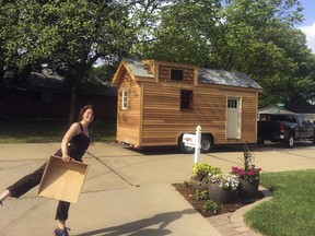 In this undated photo provided by Ryan Gines, Meghan Panu poses in front of her house in St. Louis.