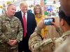 U.S. President Donald Trump and first lady Melania Trump take photos with members of the U.S. military during an unannounced visit to Al Asad Air Base in Iraq on Dec. 26, 2018.