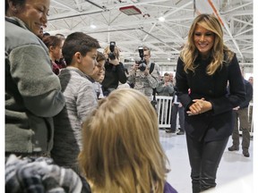 First lady Melania Trump greets children from the Burbank and Bethel Manor Elementary schools during a tour of Joint Base Langley in Hampton, Va., Wednesday, Dec. 12, 2018.