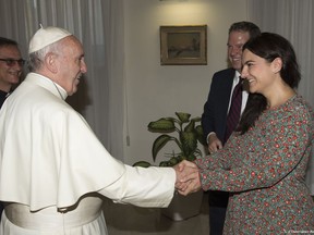 FILE - In this Monday, July 11, 2016 filer, Pope Francis greets Paloma Garcia Ovejero, right, and Greg Burke at the Vatican. The Vatican spokesman, Greg Burke, and his deputy resigned suddenly Monday, Dec. 31, 2018 amid an overhaul of the Vatican's communications operations that coincides with a troubled period in Pope Francis' papacy. In a tweet, Burke said he and his deputy, Paloma Garcia Ovejero, had resigned effective Jan. 1. (L'Osservatore Romano/Pool Photo via AP)