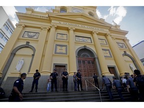 Police stand guard outside the Metropolitan Cathedral after a deadly shooting in Campinas, Brazil, Tuesday, Dec. 11, 2018. A man opened fire in the cathedral in southern Brazil after Mass on Tuesday, killing four and leaving four others injured before taking a bullet in the ribs in a firefight with police and then shooting himself in the head, authorities said.