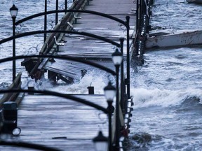 A boat is battered by waves and slammed into the White Rock Pier that was severely damaged during a windstorm, in White Rock, B.C., on Thursday December 20, 2018. One person who was trapped on the pier had to be rescued by helicopter.