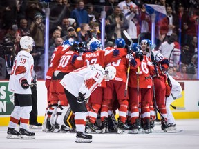 Switzerland's Justin Sigrist (13) and Yannick Bruschweiler (10) skate past as Czech Republic players celebrate their overtime win during world junior hockey championship action in Vancouver, on Wednesday December 26, 2018.