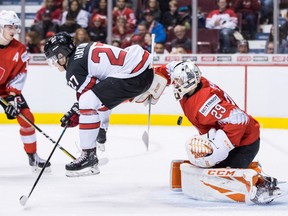 Canada's Barrett Hayton (27) jumps in front of Switzerland goalie Akira Schmid as he makes the save during second period IIHF world junior hockey championship action in Vancouver, on Thursday December 27, 2018.