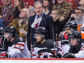 Canada head coach Tim Hunter stands on the bench during third period IIHF world junior hockey championship action against Switzerland in Vancouver, on Thursday December 27, 2018.