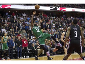 Boston Celtics guard Kyrie Irving (11) shoots with Washington Wizards guard Bradley Beal (3) nearby during the overtime period of an NBA basketball game Wednesday, Dec. 12, 2018, in Washington. The Celtics won 130-125.