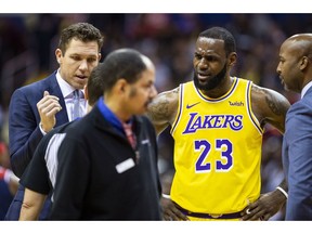 Los Angeles Lakers forward LeBron James (23) and head coach Luke Walton dispute a call during the first half of an NBA basketball game, Sunday, Dec. 16, 2018, in Washington.