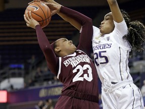 Mississippi State's Bre'Amber Scott (23) tries to get a shot past Washington's T.T. Watkins (25) during the first half of an NCAA college basketball game Thursday, Dec. 20, 2018, in Seattle.