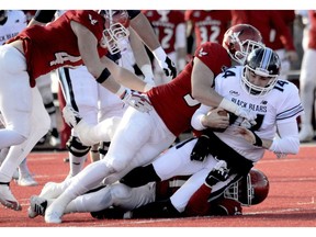 Eastern Washington Eagles Mitchell Johnson (94) and Jonah Jordan (91) sack Maine's quarterback Chris Ferguson during the first half of a college football game on Saturday, Dec.15, 2018, in Cheney, Wash.