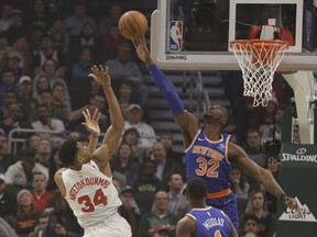 Milwaukee Bucks' Giannis Antetokounmpo (34) has his shot blocked by New York Knicks' Noah Vonieh (32) during the first half of an NBA basketball game Thursday, Dec. 27, 2018, in Milwaukee.