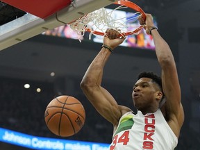 Milwaukee Bucks' Giannis Antetokounmpo dunks during the first half of an NBA basketball game against the Milwaukee Bucks Saturday, Dec. 29, 2018, in Milwaukee.