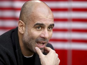 Manchester City manager Pep Guardiola looks out prior to the match against Southampton, during their English Premier League soccer match at St Mary's Stadium in Southampton, England, Sunday Dec. 30, 2018.