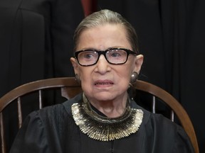 FILE - In this Nov. 30, 2018 file photo, Associate Justice Ruth Bader Ginsburg, nominated by President Bill Clinton, sits with fellow Supreme Court justices for a group portrait at the Supreme Court Building in Washington, Friday. The Supreme Court says Justice Ruth Bader Ginsburg has undergone surgery to remove two malignant growths from her left lung. It is Ginsburg's third bout with cancer since joining the court in 1993.