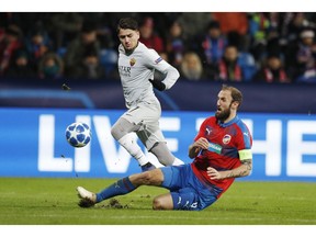 Roma's Cengiz Under, left, challenges for the ball with Plzen's Roman Hubnik during the Champions League group G soccer match between Viktoria Plzen and Roma at the Doosan arena in Pilsen, Czech Republic, Wednesday, Dec. 12, 2018.