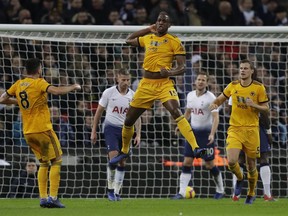 Wolverhampton Wanderers Willy Boly leaps up as he celebrates scoring his sides 1st goal during their English Premier League soccer match between Tottenham Hotspur and Wolverhampton Wanderers at Wembley stadium in London, Saturday, Dec. 29, 2018.