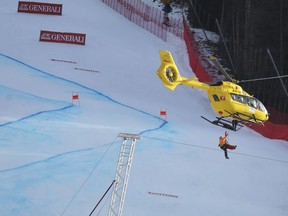 Slovenia's Klemen Kosi not seen in the picture is carried by an helicopter to be transferred to an hospital after crashing during a ski World Cup Men's Downhill in Bormio, Italy, Friday, Dec.28, 2018.
