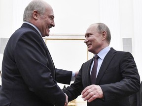 Russian President Vladimir Putin, right, and his Belarusian counterpart Alexander Lukashenko greet each other prior to their talks in the Kremlin in Moscow, Russia, Tuesday, Dec. 25, 2018.
