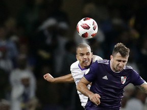 Emirates's Al Ain Ismail Ahmed, left, jumps for the ball with Argentina's River Plate Lucas Pratto during the Club World Cup semifinal soccer match between Al Ain Club and River Plate at the Hazza Bin Zayed stadium in Al Ain, United Arab Emirates, Tuesday, Dec. 18, 2018.