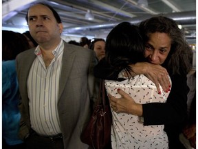 El Nacional newspaper employees become emotional during a news conference in their newsroom in Caracas, Venezuela, Friday, Dec. 14, 2018. Venezuela's last nationally circulated, anti-government newspaper stopped publishing its print edition amid unrelenting government pressure and paper shortages. El Nacional's final edition published Friday after 75 years in print. It will become an exclusively online publication.